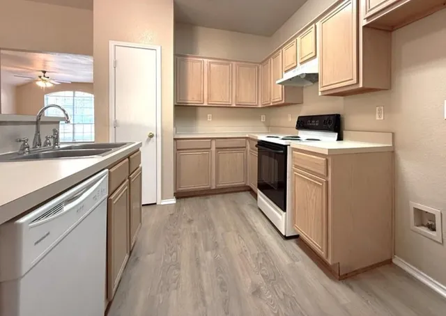 a kitchen with a sink stove and cabinets