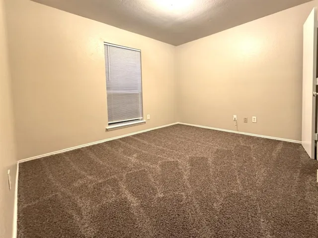a bathroom with a bathtub shower sink vanity mirror and toilet