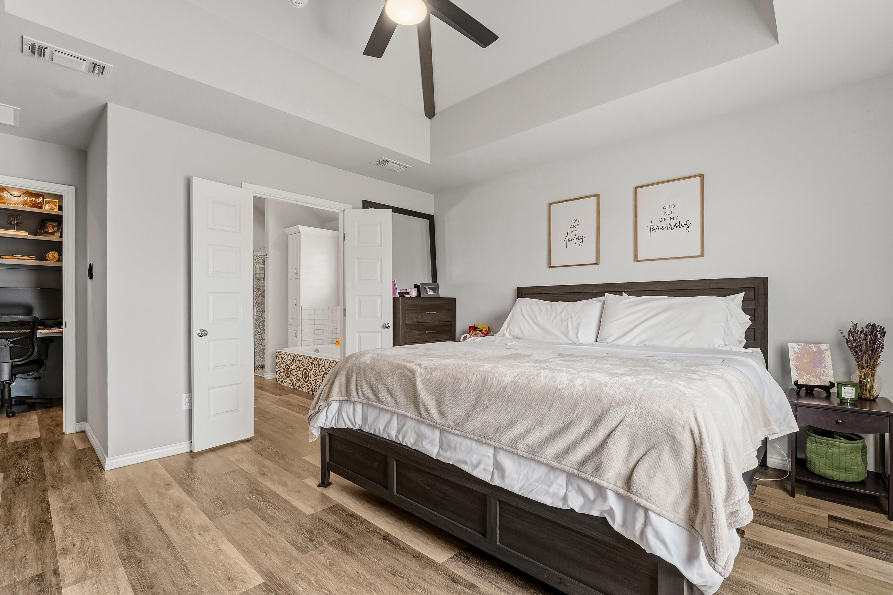 3611 133rd Street Lubbock, TX 79423 - Photo 17 of 31 a bedroom with a bed and a chandelier