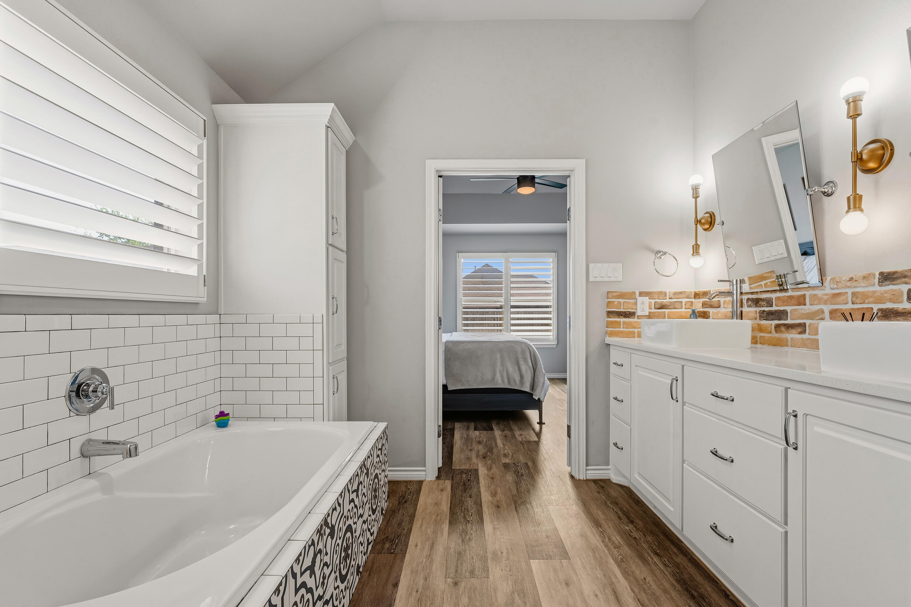 3611 133rd Street Lubbock, TX 79423 - Photo 21 of 31 a bathroom with a tub sink and mirror