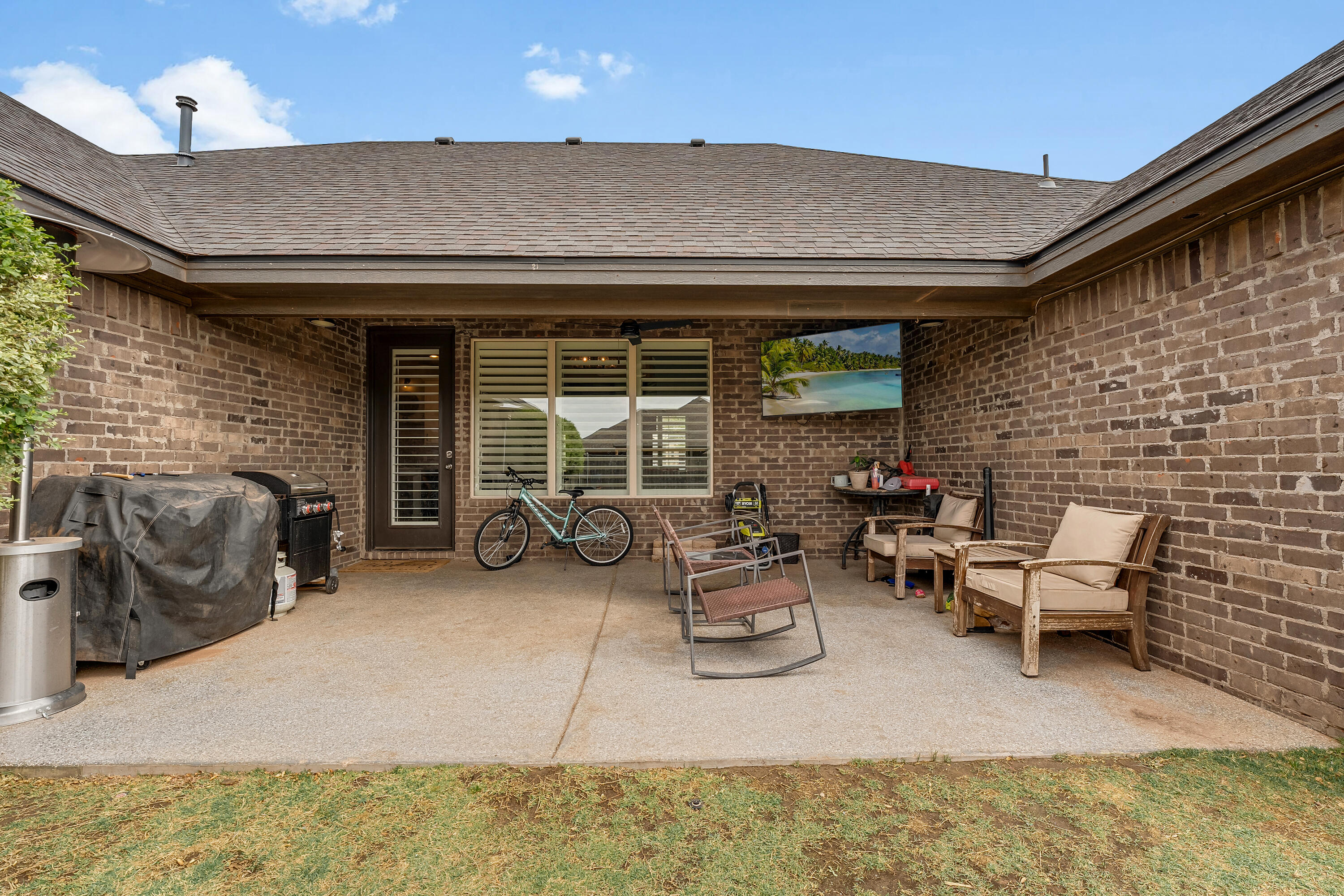 3611 133rd Street Lubbock, TX 79423 - Photo 30 of 31 a view of a patio with table and chairs and barbeque