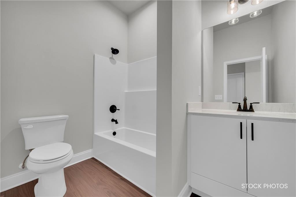 1038 Homestead Way Street Dacula, GA 30019 - Photo 22 of 36 a bathroom with a sink a toilet and shower