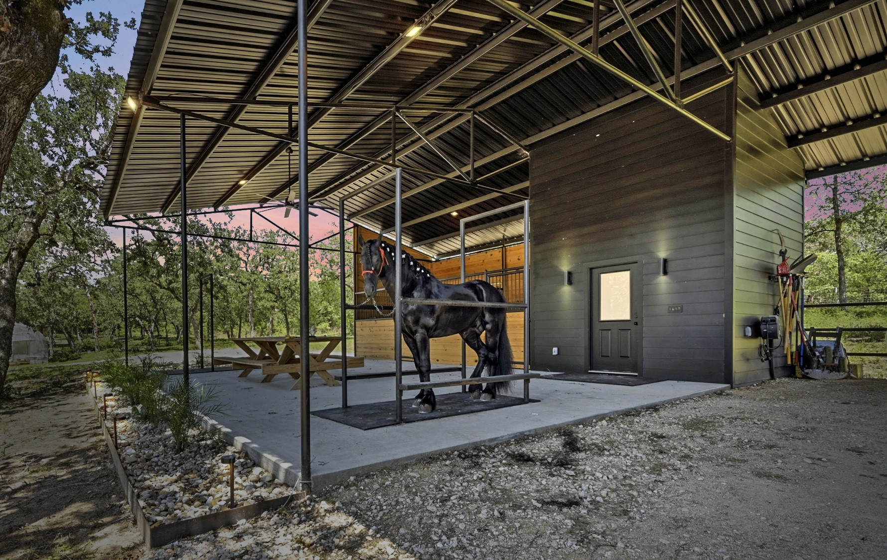 387 Corral Road Smithville, TX 78957 - Photo 5 of 40 Covered outdoor structure with a metal roof and exposed steel framing