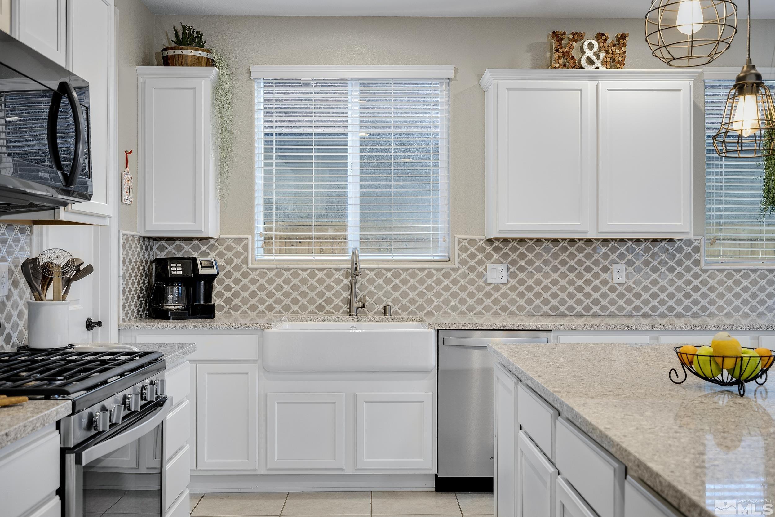 3300 Show Jumper Lane Reno, NV 89521 - Photo 16 of 40 a kitchen with granite countertop a sink a stove and cabinets