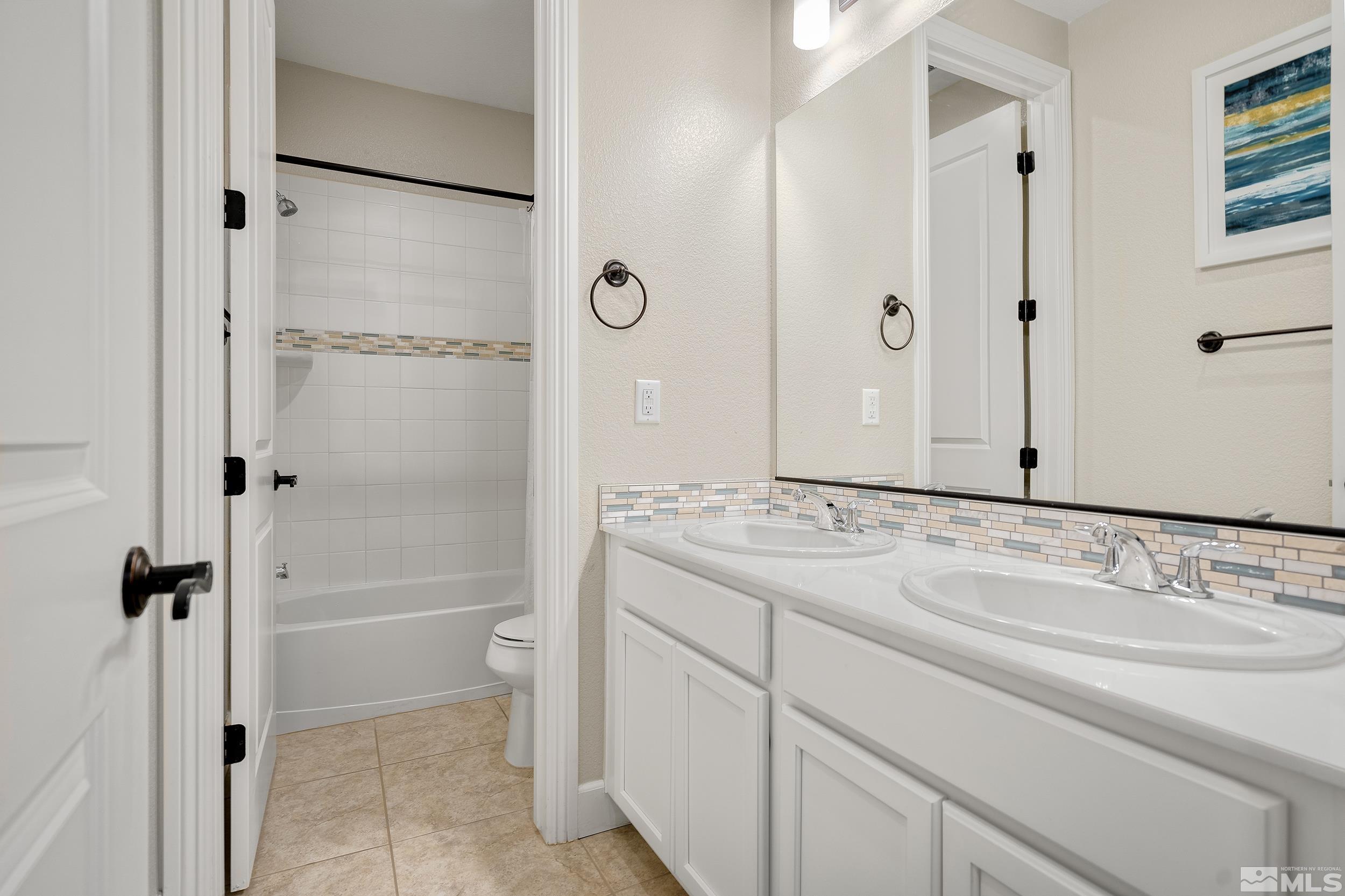 3300 Show Jumper Lane Reno, NV 89521 - Photo 21 of 40 a bathroom with a granite countertop sink toilet and shower
