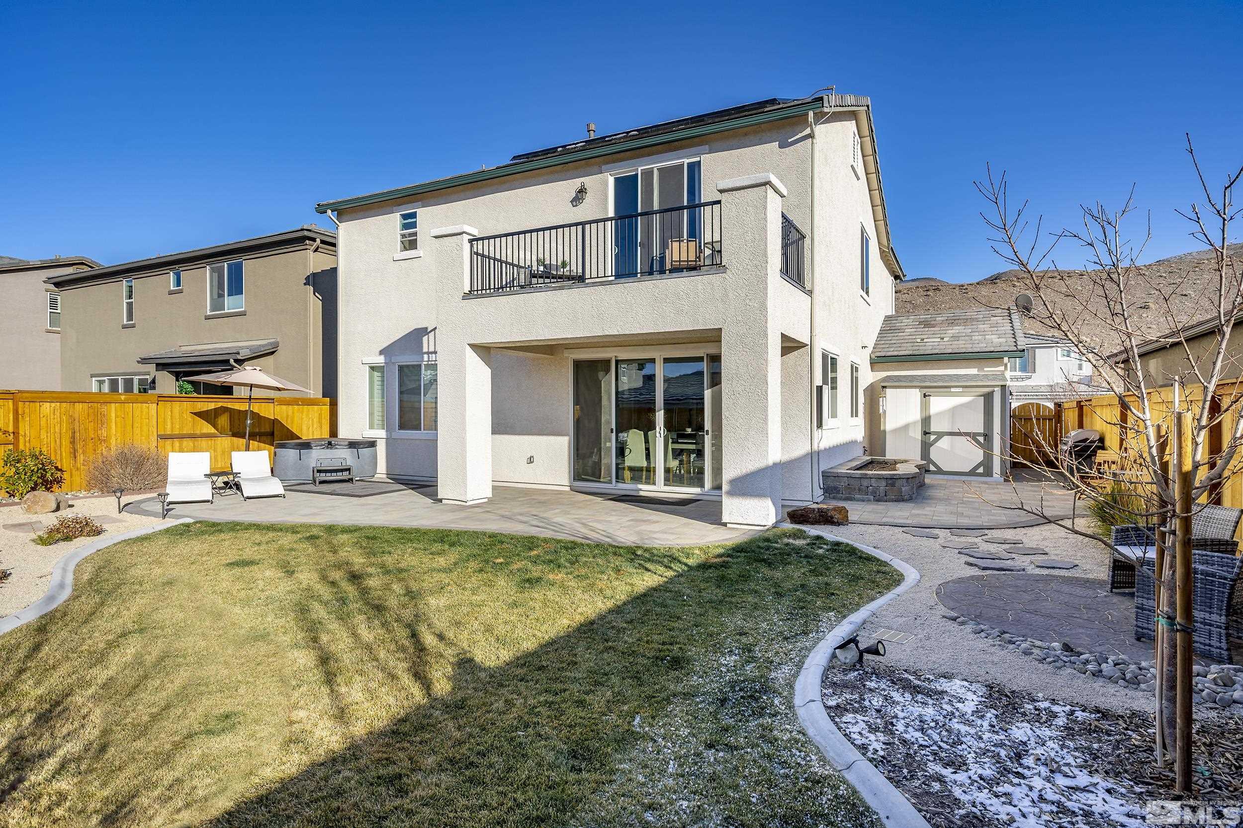 3300 Show Jumper Lane Reno, NV 89521 - Photo 33 of 40 a view of a white house with a swimming pool and a yard