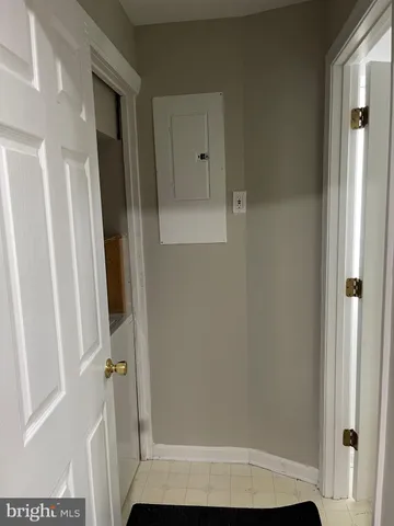 a view of a livingroom with furniture and a hallway