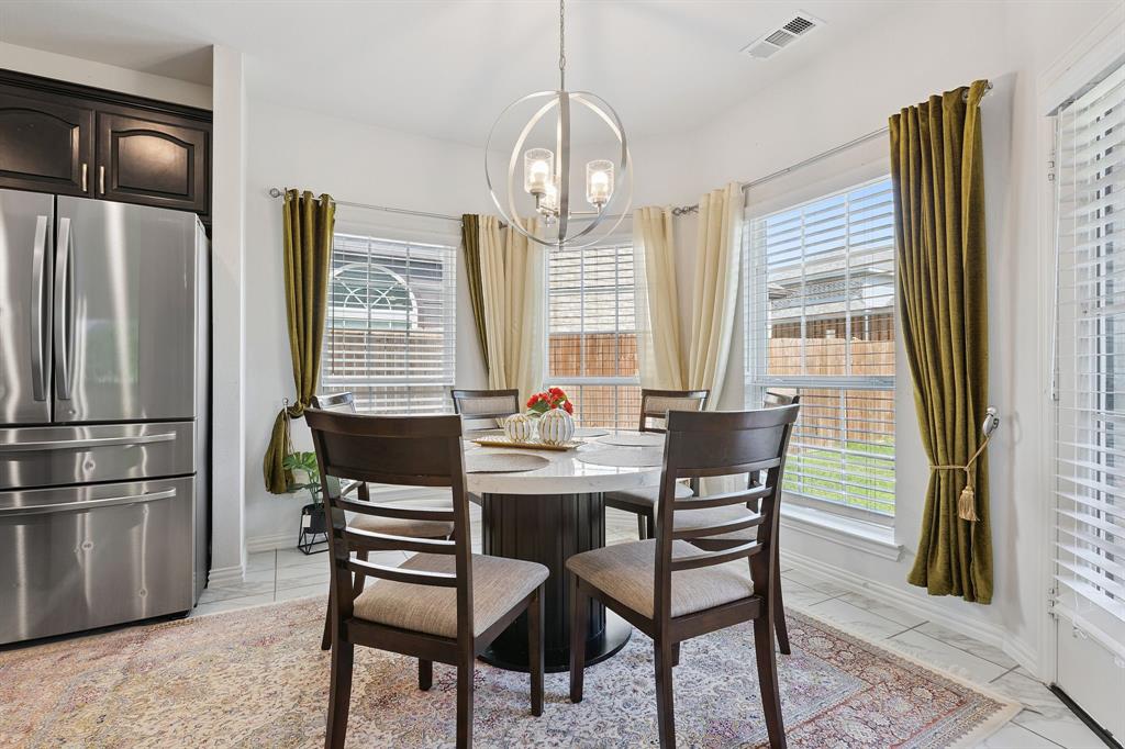 Undisclosed Address Wylie, TX 75098 - Photo 12 of 26 Breakfast area featuring a chandelier, light marble finish floors, and healthy amount of natural light
