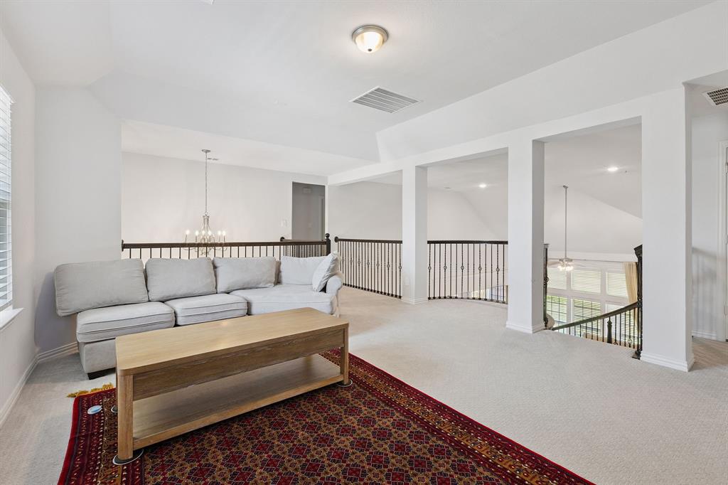 Undisclosed Address Wylie, TX 75098 - Photo 18 of 26 Living room with a chandelier, ceiling fan, and lofted ceiling