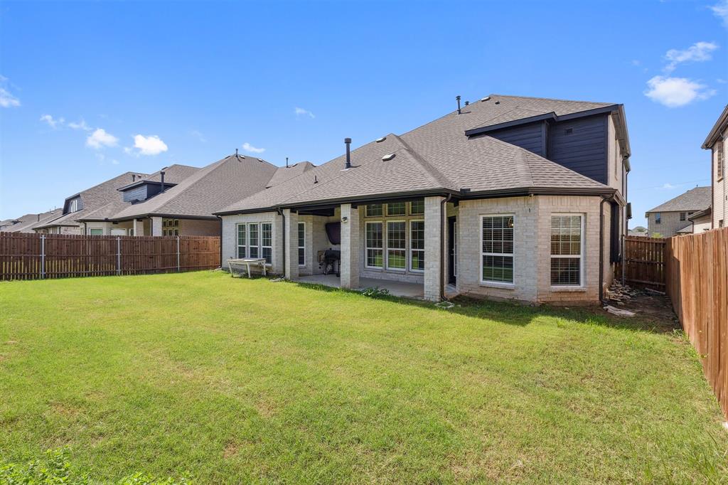 Undisclosed Address Wylie, TX 75098 - Photo 26 of 26 Rear view of house with a shingled roof, a fenced backyard, and brick siding
