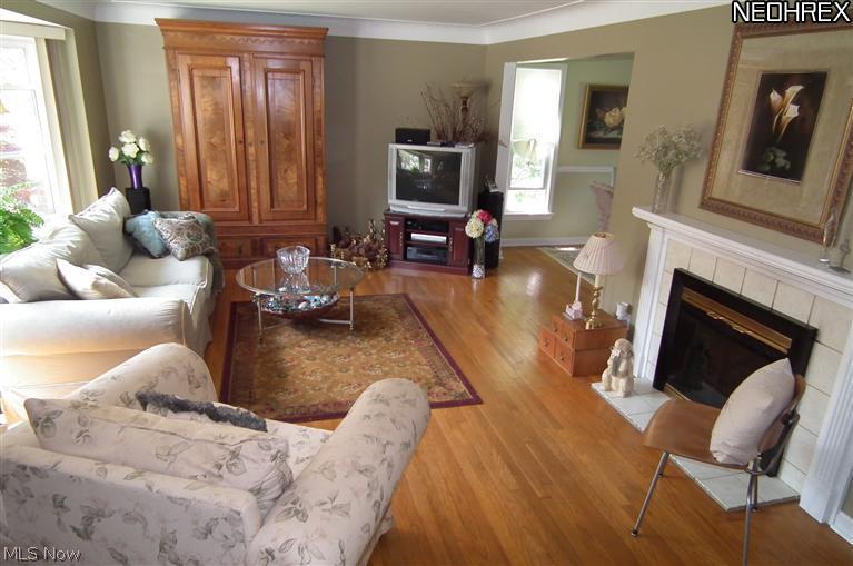 2544 Laurelhurst Road Cleveland, OH 44118 - Photo 2 of 14 LIVING ROOM WITH WOOD FLOORS, FIREPLACE AND PICTURE WINDOW! THE WHOLE HOUSE HAS NEW WINDOWS!