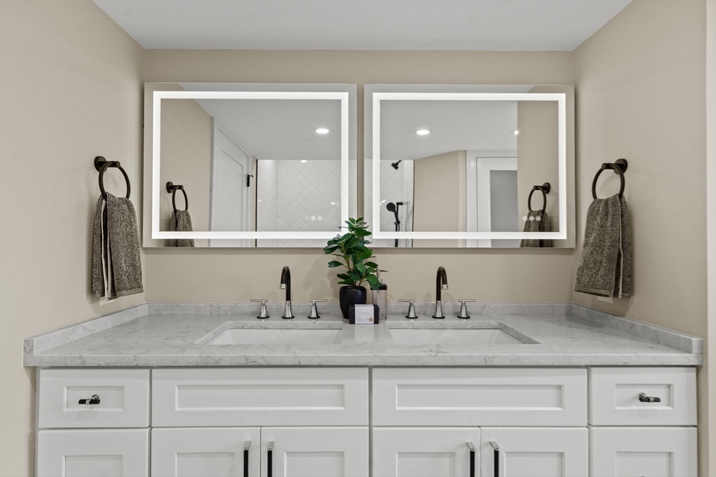 162 High Street, Unit B Danvers, MA 01923 - Photo 26 of 32 a bathroom with sink and mirror
