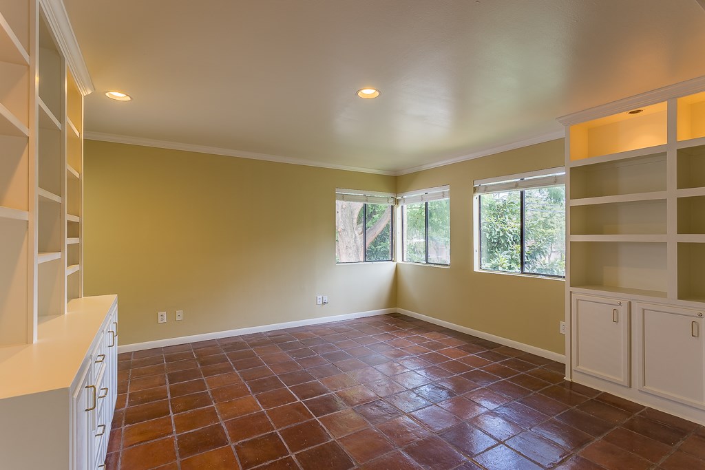 2349 Albans Road, Unit 2 Houston, TX 77005 - Photo 10 of 25 This versatile dining room, bathed in natural light and featuring elegant built-in shelves, offers the perfect space for a cozy second bedroom or an inviting dining area, adaptable to your lifestyle needs.