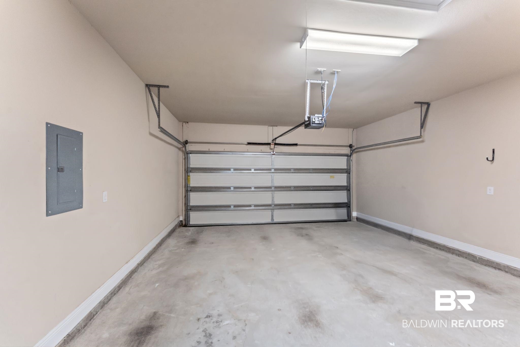 1464 Surrey Loop Foley, AL 36535 - Photo 23 of 24 Garage with electric panel and a garage door opener