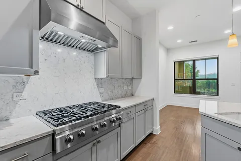 a kitchen with stainless steel appliances a stove sink and refrigerator
