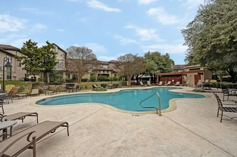 a view of a swimming pool with outdoor seating