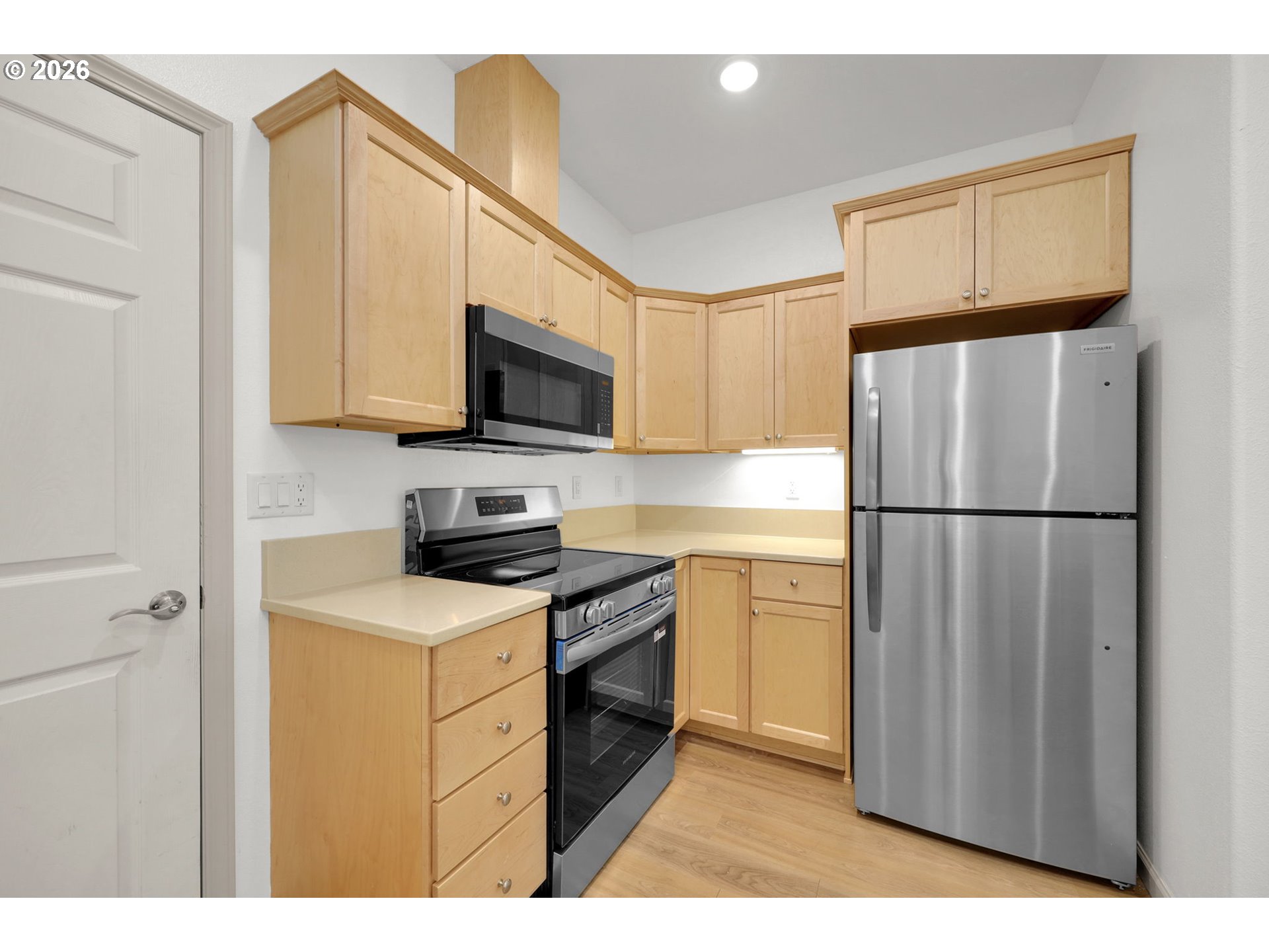 1726 32nd Street Florence, OR 97439 - Photo 11 of 38 a kitchen with stainless steel appliances granite countertop a refrigerator stove a sink and a microwave