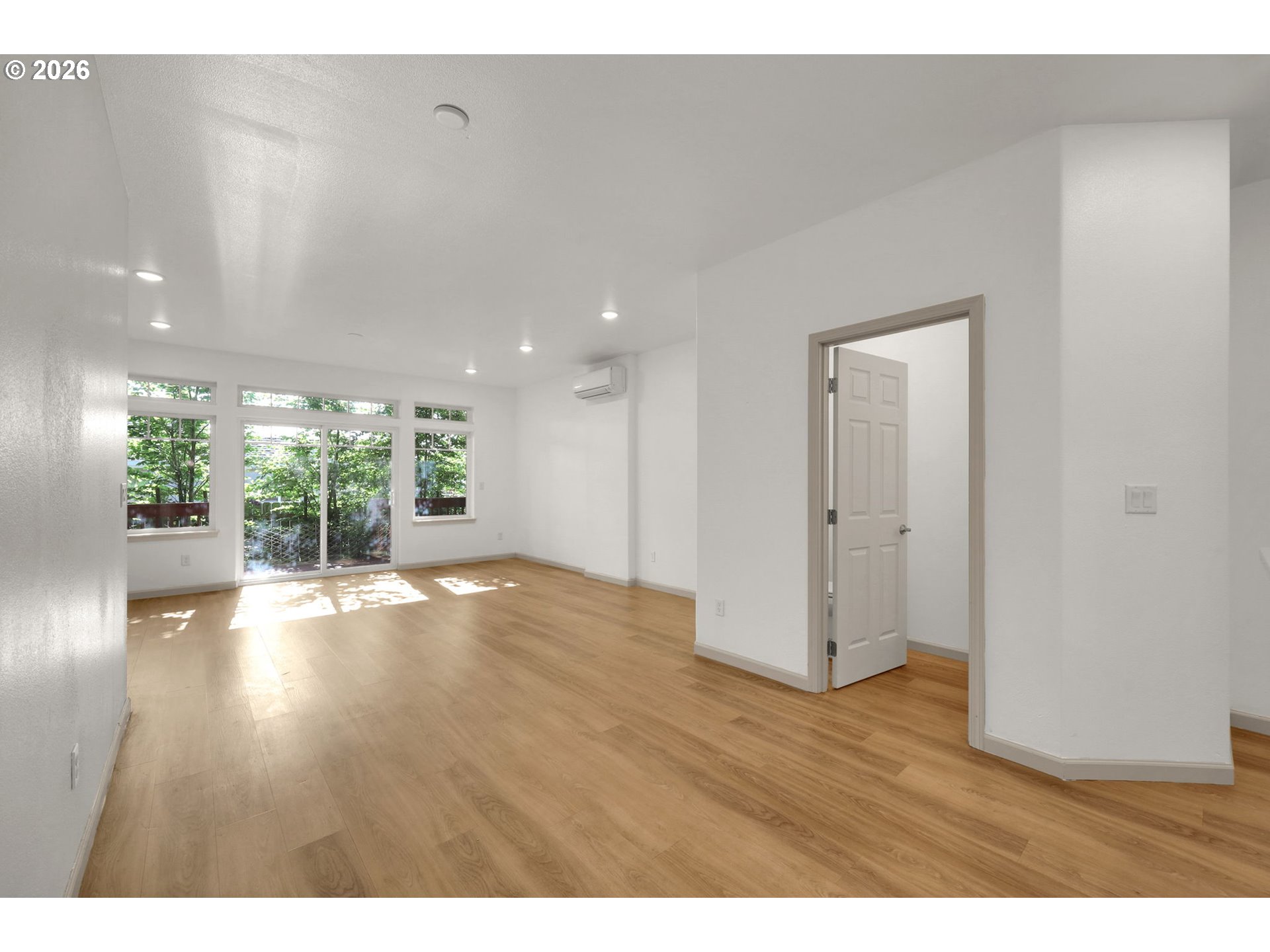 1726 32nd Street Florence, OR 97439 - Photo 13 of 38 a view of an empty room with wooden floor and a window