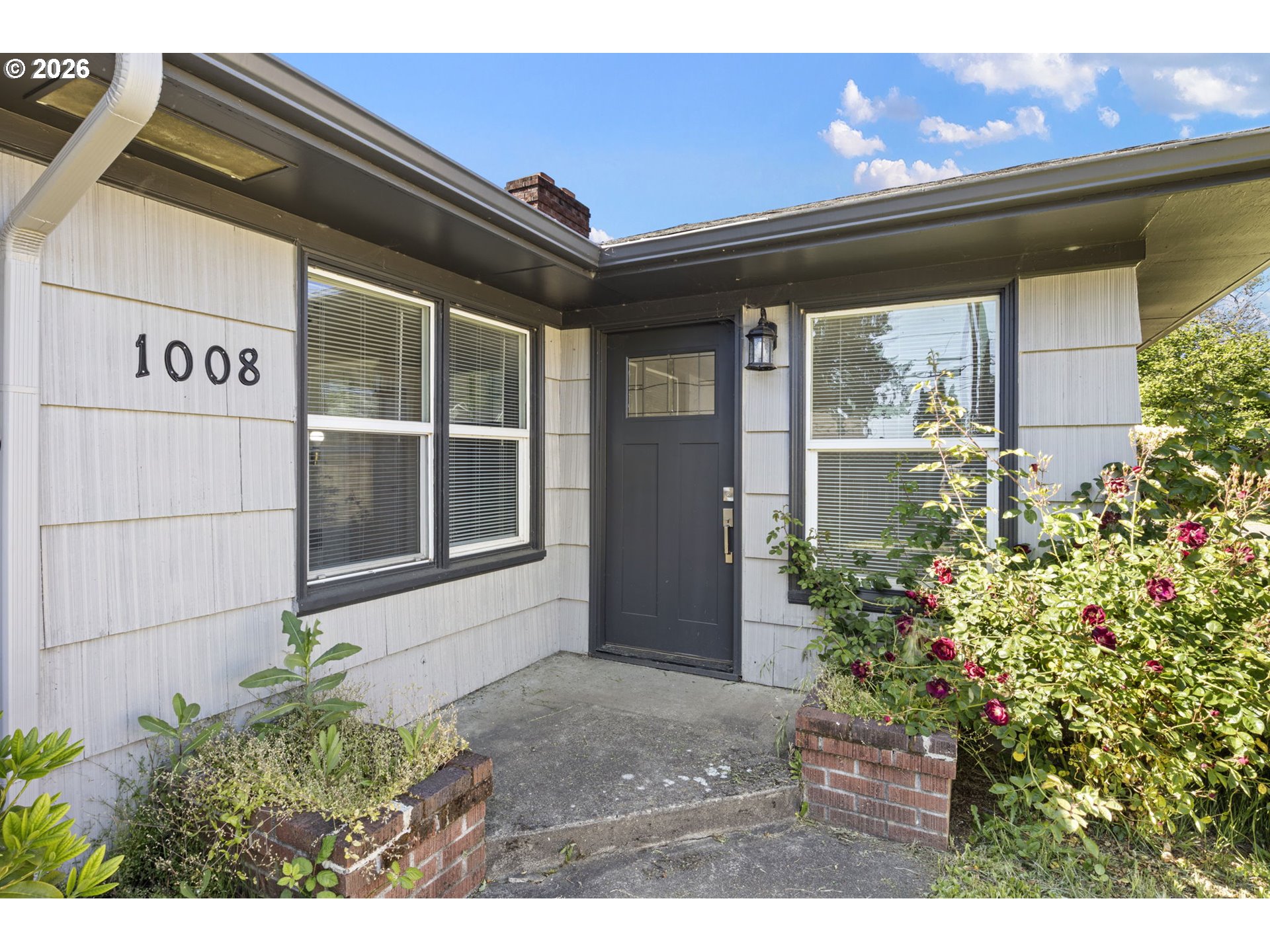 1008 Coburg Road Eugene, OR 97401 - Photo 23 of 46 a front view of a house with a garden