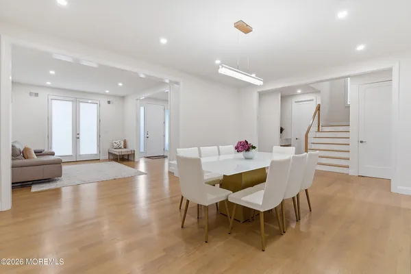 a dining room with furniture and wooden floor