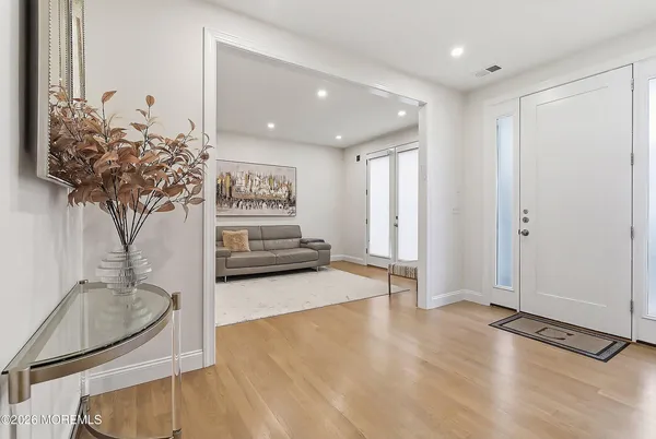 a living room with furniture and a dining table with kitchen view