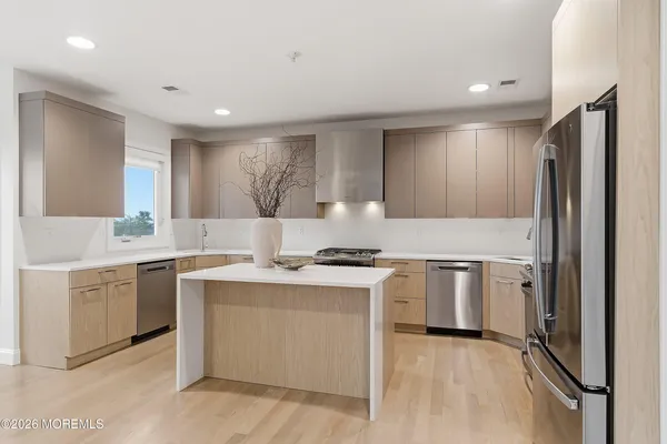 a kitchen with a stove a refrigerator and a sink