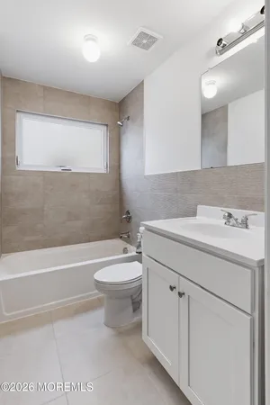 a bathroom with a sink a toilet and bathtub