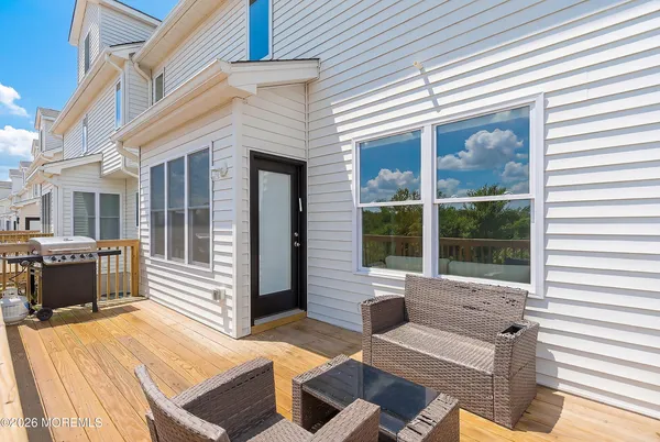 a view of a patio with couches chairs and large windows
