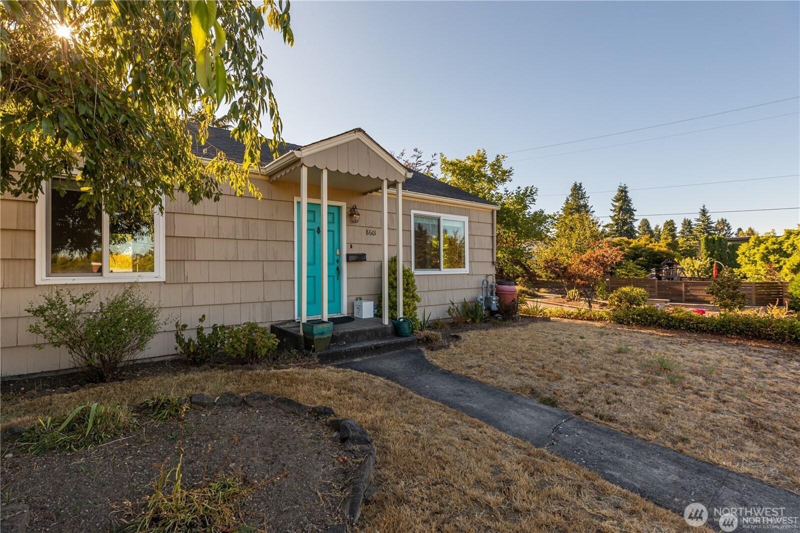 8601 36th Avenue Southwest Seattle, WA 98126 - Photo 1 of 28 a front view of a house with a yard and a garage