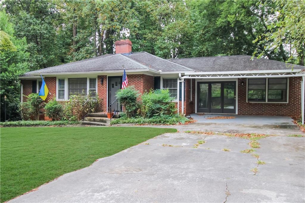 a front view of a house with a garden