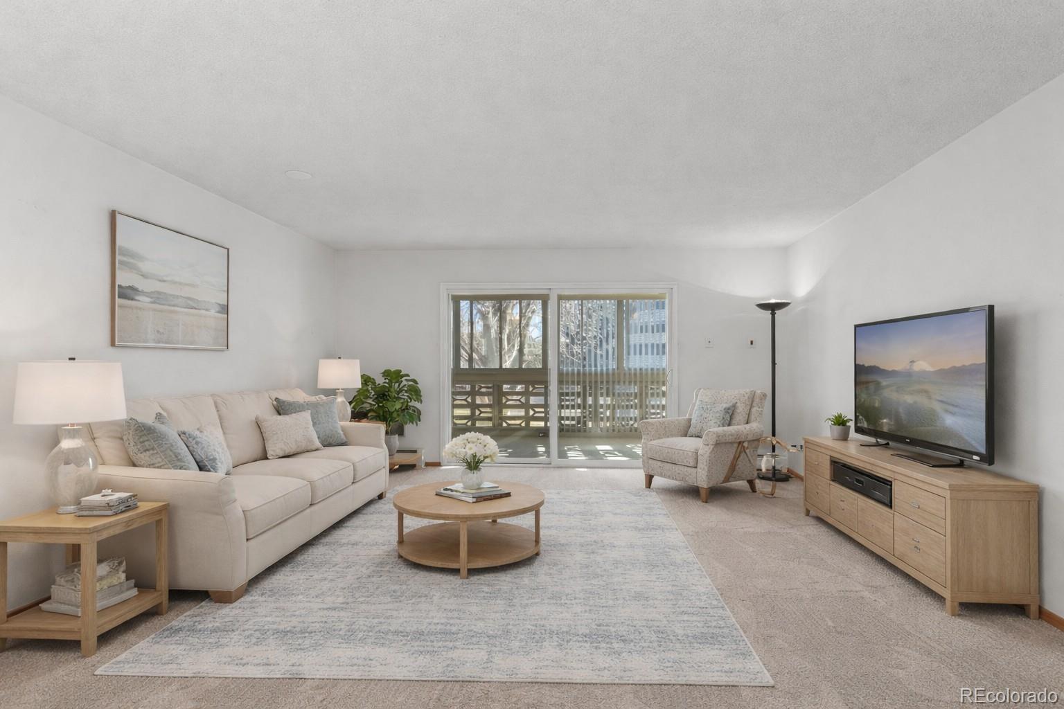 750 South Clinton Street, Unit 2B Denver, CO 80247 - Photo 1 of 43 a living room with furniture and a flat screen tv
