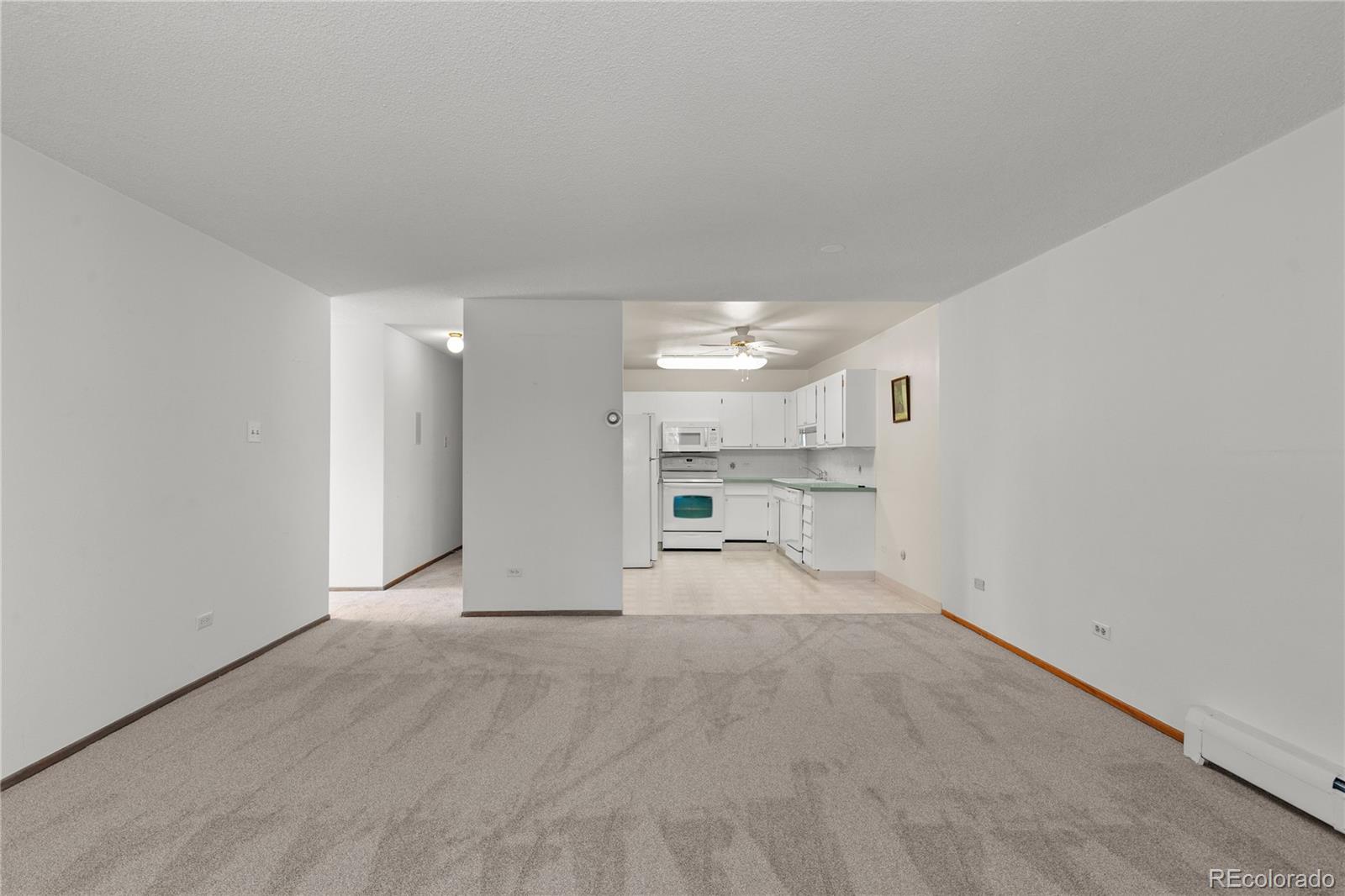 750 South Clinton Street, Unit 2B Denver, CO 80247 - Photo 11 of 43 a view of a room with a empty space and windows