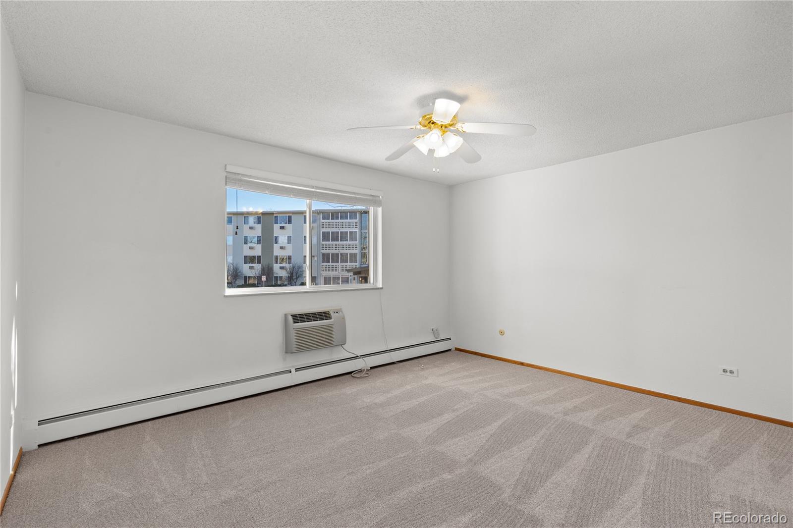 750 South Clinton Street, Unit 2B Denver, CO 80247 - Photo 15 of 43 an empty room with a window