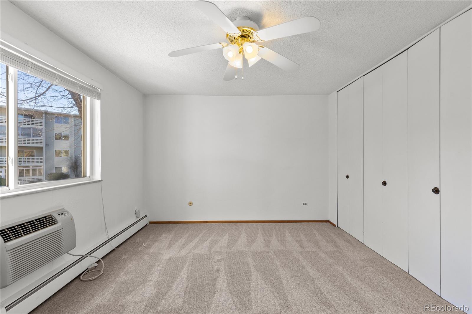 750 South Clinton Street, Unit 2B Denver, CO 80247 - Photo 16 of 43 wooden floor in an empty room with a window