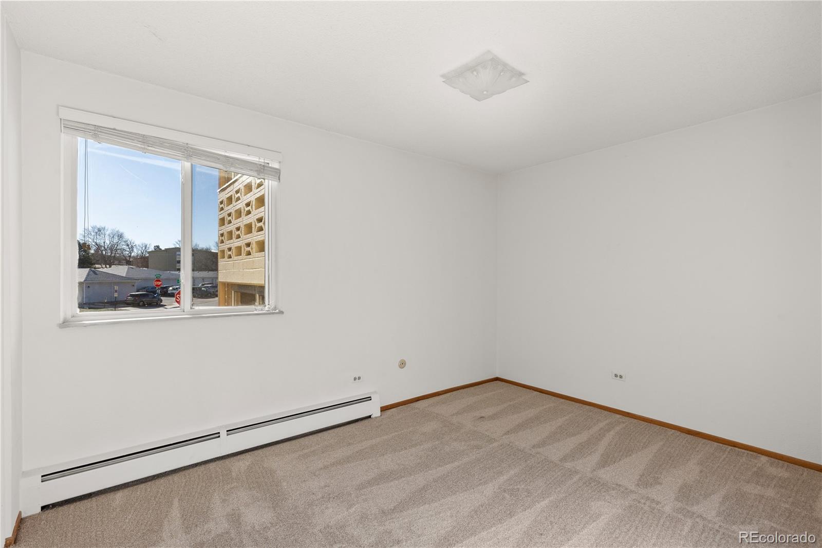 750 South Clinton Street, Unit 2B Denver, CO 80247 - Photo 18 of 43 an empty room with a window