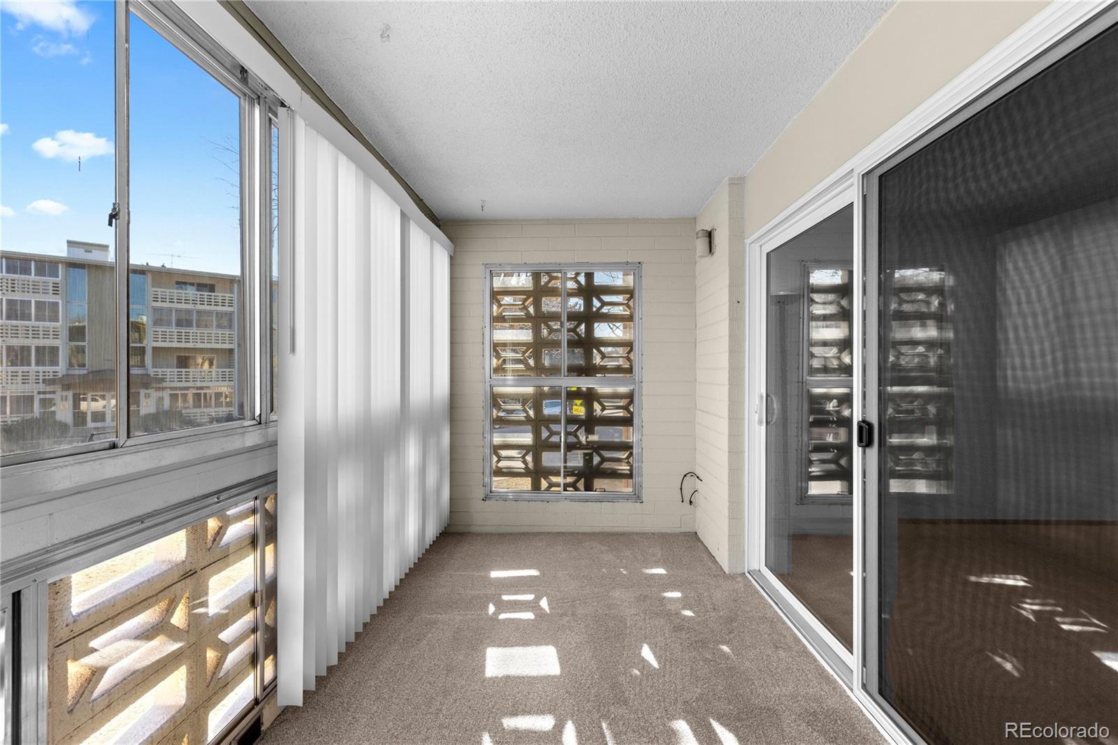 750 South Clinton Street, Unit 2B Denver, CO 80247 - Photo 23 of 43 a view of a hallway with wooden shelves and stairs