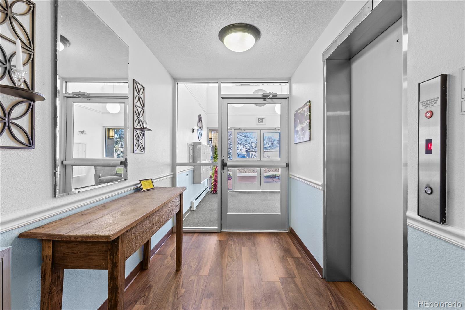 750 South Clinton Street, Unit 2B Denver, CO 80247 - Photo 31 of 43 a kitchen with a wooden floor and a refrigerator