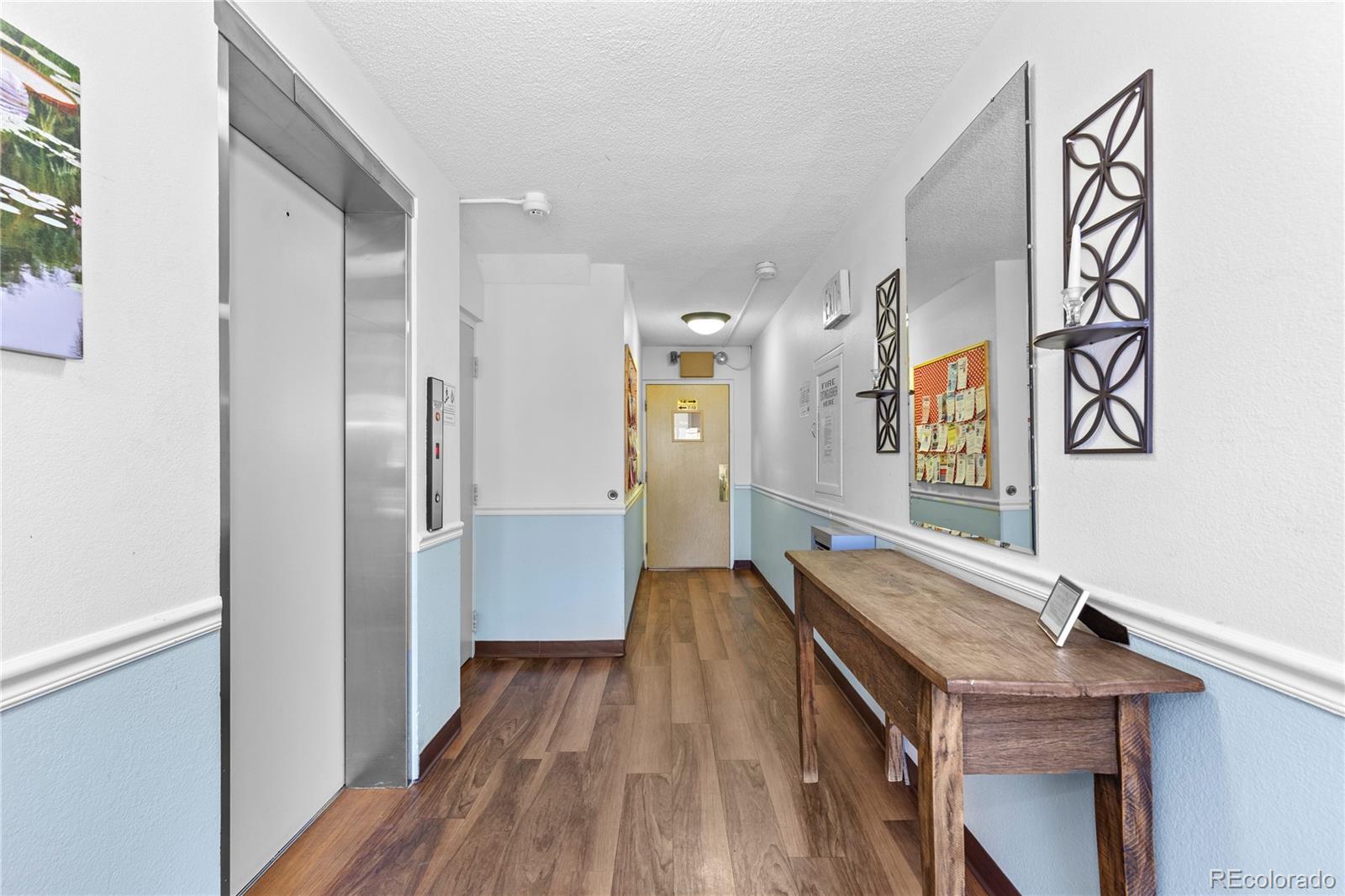 750 South Clinton Street, Unit 2B Denver, CO 80247 - Photo 32 of 43 a view of a hallway with wooden floor