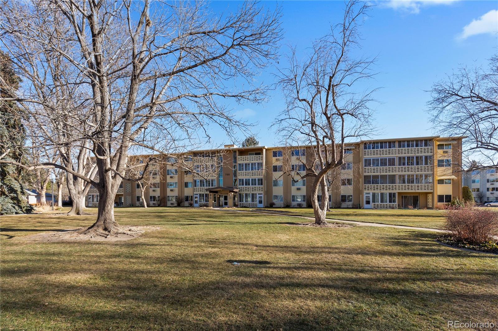 750 South Clinton Street, Unit 2B Denver, CO 80247 - Photo 40 of 43 a building with trees in front of it