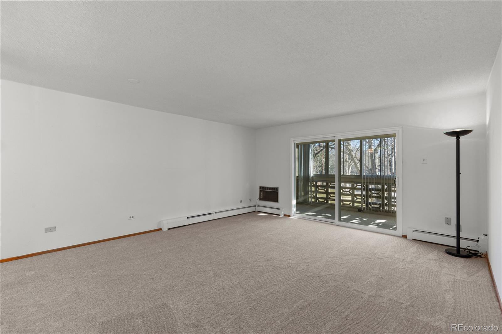 750 South Clinton Street, Unit 2B Denver, CO 80247 - Photo 7 of 43 an empty room with floor to ceiling window and an empty room