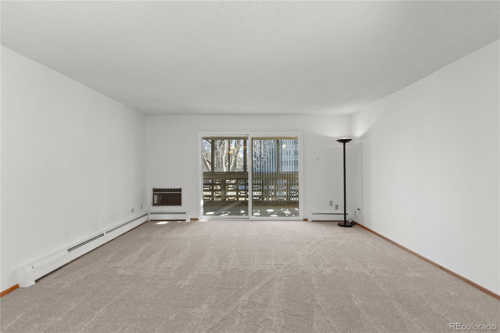 750 South Clinton Street, Unit 2B Denver, CO 80247 - Photo 8 of 43 an empty room with floor to ceiling window