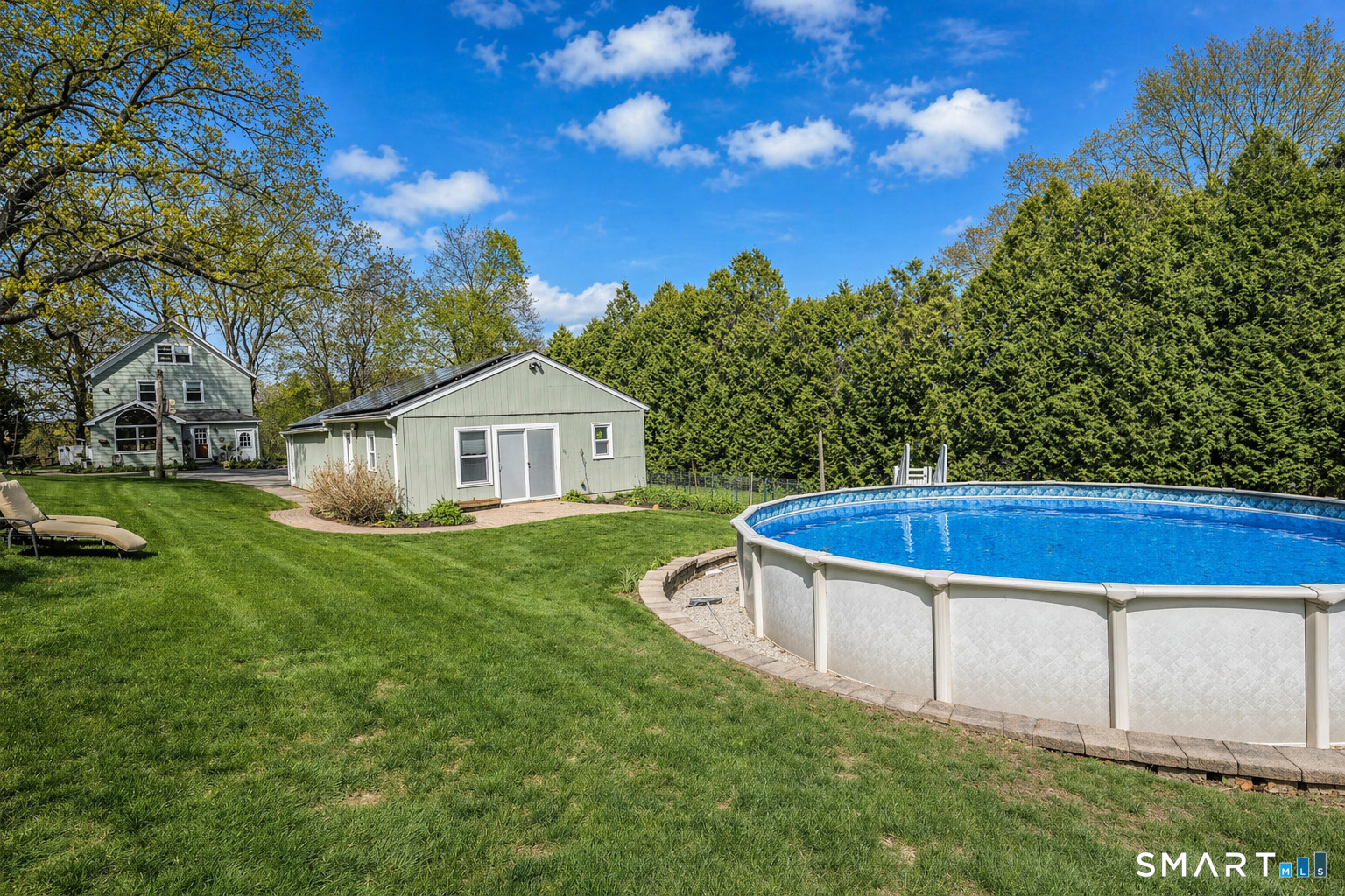 53 Cedar Street Middlefield, CT 06481 - Photo 4 of 30 Private outdoor setting with pool, mature landscaping, and bonus studio space for added flexibility.