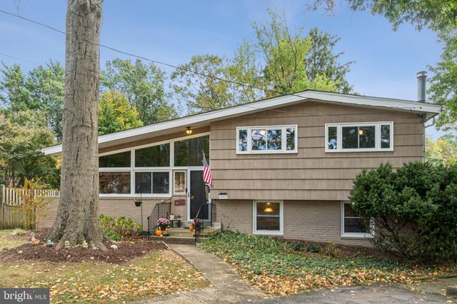 a house that has a tree in front of it
