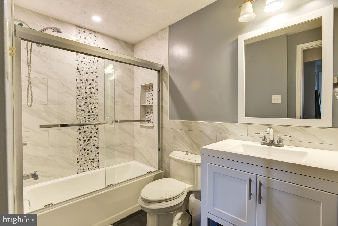 7310 Torran Rocks Way Gaithersburg, MD 20879 - Photo 19 of 32 a bathroom with a sink a toilet and shower