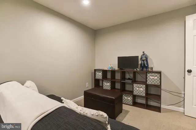 a bedroom with a bed and a television