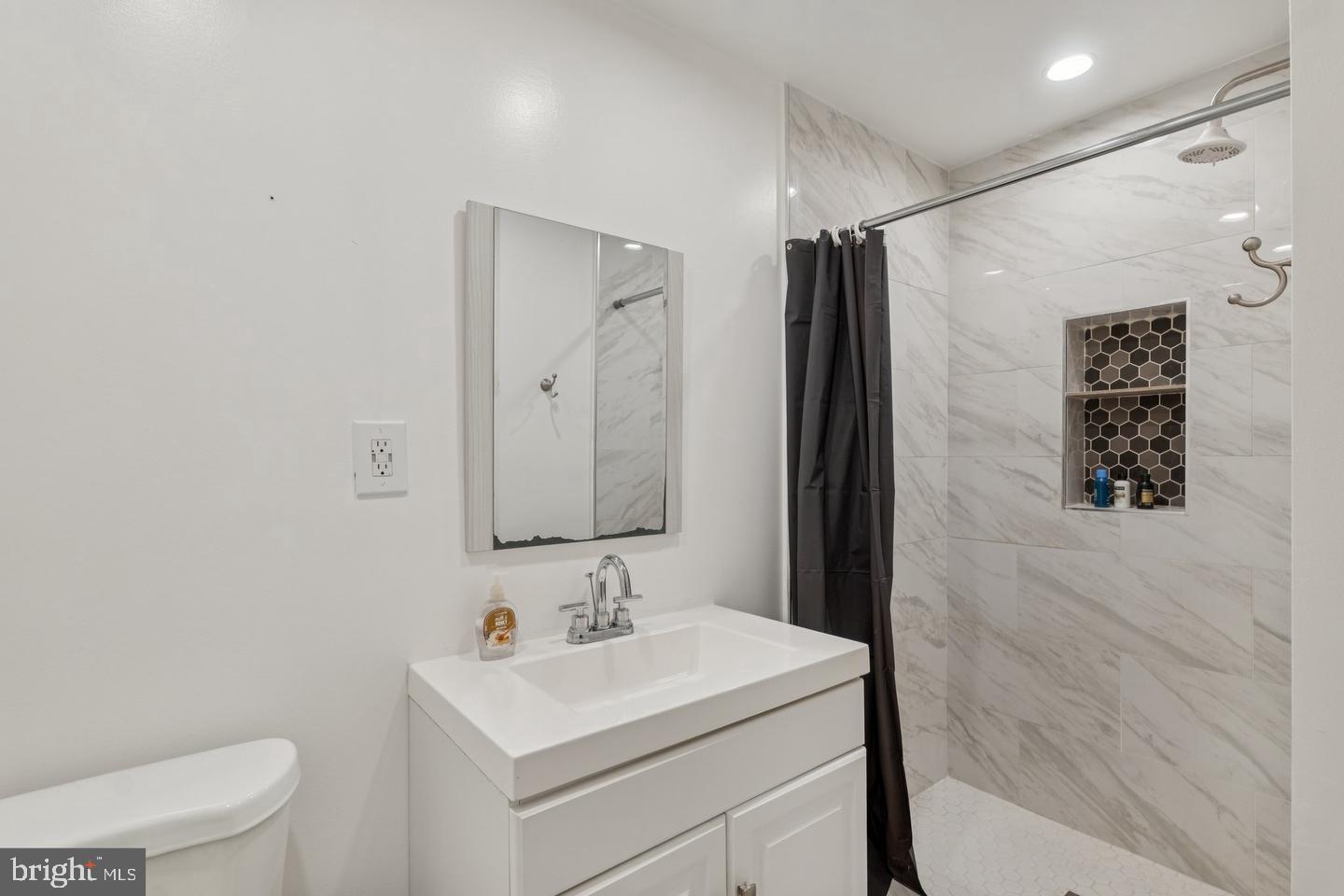 7310 Torran Rocks Way Gaithersburg, MD 20879 - Photo 22 of 32 a bathroom with a sink toilet and shower
