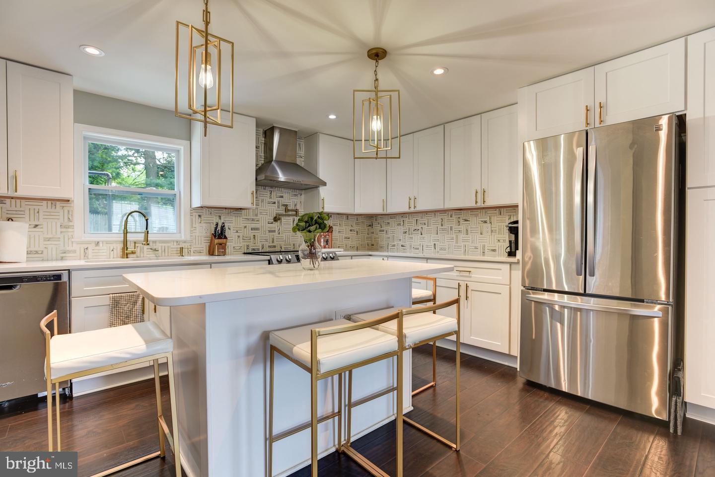 7310 Torran Rocks Way Gaithersburg, MD 20879 - Photo 5 of 32 a kitchen with stainless steel appliances granite countertop a refrigerator a sink dishwasher a stove and white cabinets with wooden floor