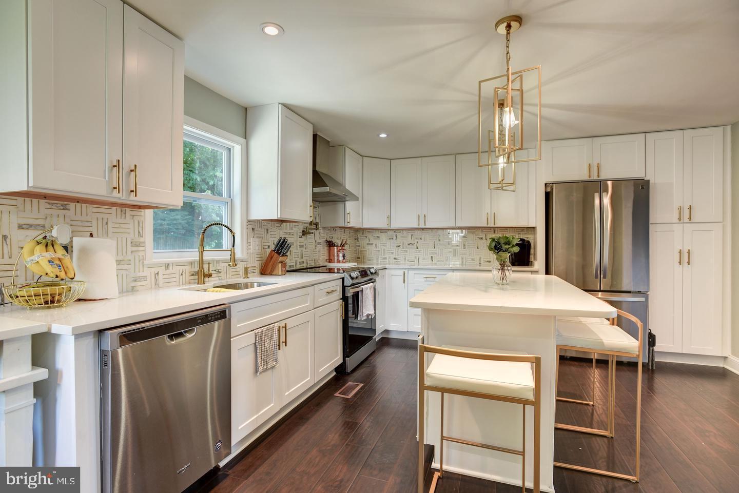 7310 Torran Rocks Way Gaithersburg, MD 20879 - Photo 8 of 32 a kitchen with a sink a center island stainless steel appliances and cabinets