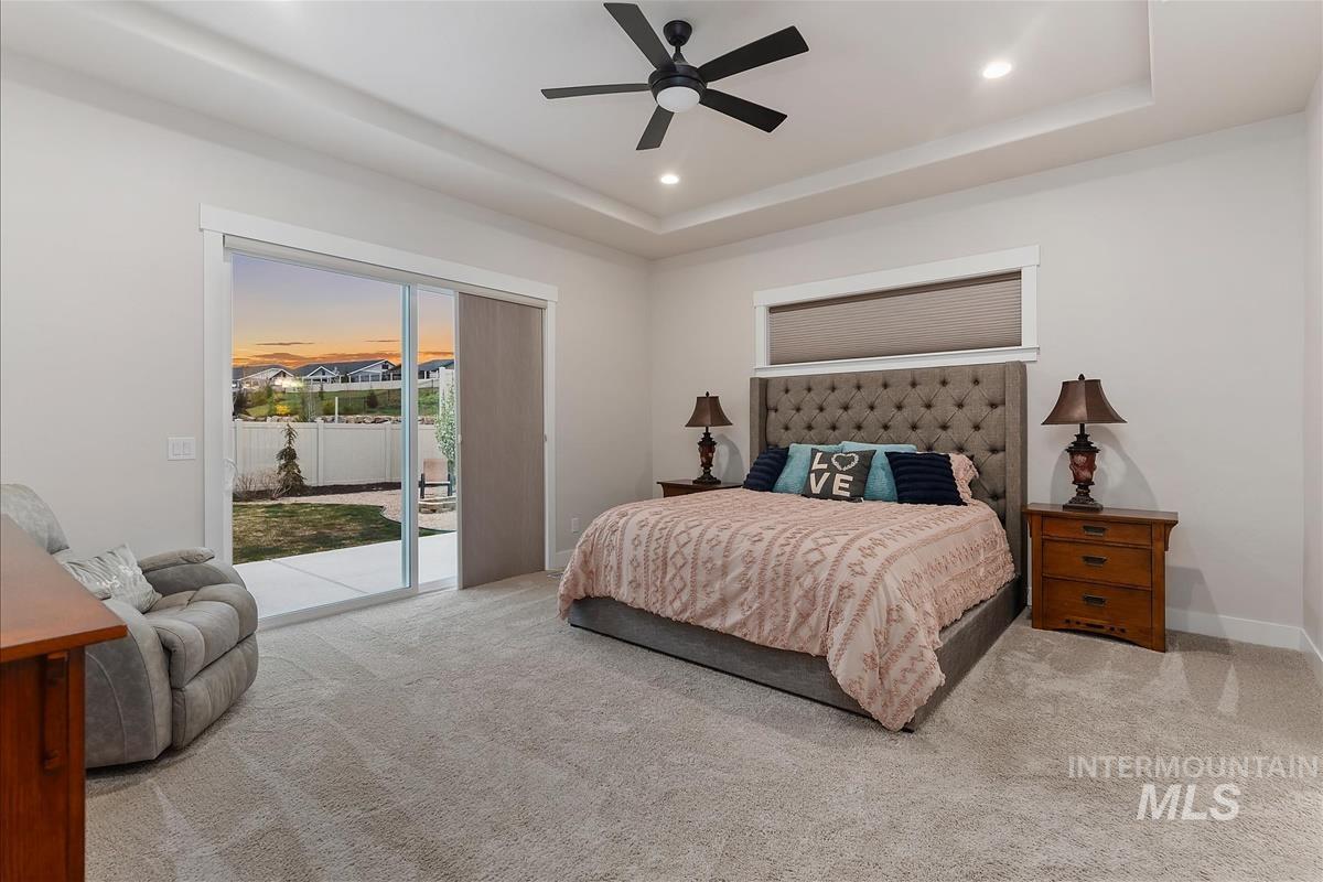 3413 North Hosta Avenue Star, ID 83669 - Photo 13 of 50 Bedroom with access to outside, a tray ceiling, ceiling fan, light colored carpet, and recessed lighting