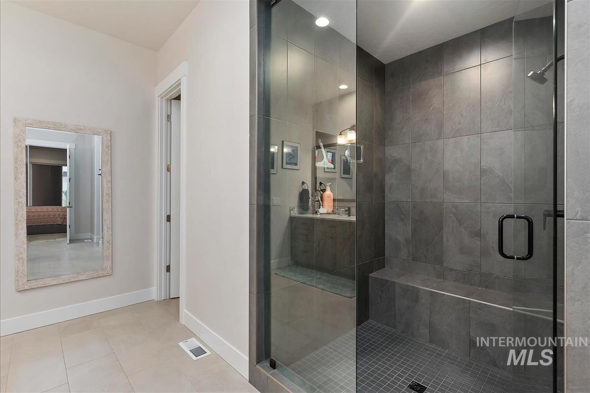 3413 North Hosta Avenue Star, ID 83669 - Photo 18 of 50 Bathroom featuring a shower stall, light tile patterned floors, and vanity